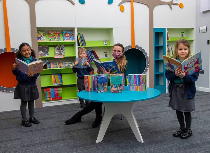 Housebuilder’s donation helps fill school’s library